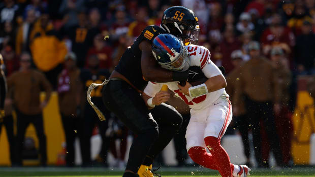 Washington Commanders defensive end KJ Henry (55) sacks New York Giants quarterback Tommy DeVito (15) during the first quarter at FedExField.